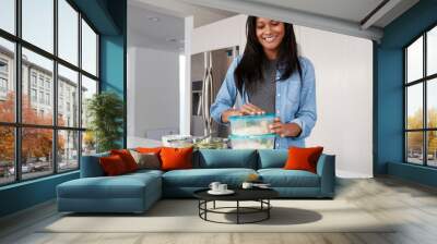 Woman In Kitchen Preparing High Protein Meal And Putting Portions Into Plastic Containers Wall mural