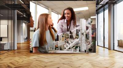 Woman Teacher With Female College Students Building Machine In Science Robotics Or Engineering Class Wall mural