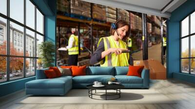 Woman using a barcode reader in a distribution warehouse Wall mural