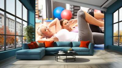 Women Doing Stretching Exercises In Gym Wall mural