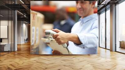 worker scanning package in warehouse Wall mural