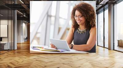 Young African American woman working with tablet in office Wall mural