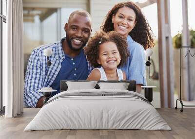 Young black family embracing outdoors and smiling at camera Wall mural