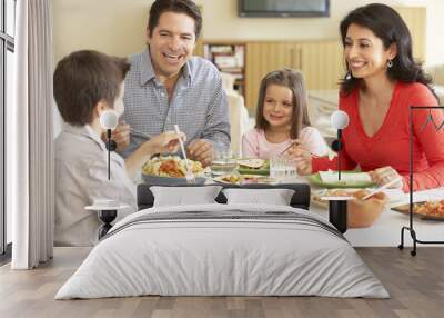 Young Hispanic Family Enjoying Meal At Home Wall mural