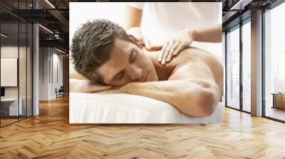 young man enjoying massage at spa Wall mural