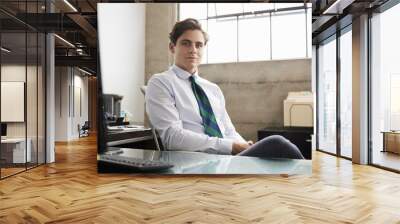 Young white businessman at an office desk looking to camera Wall mural