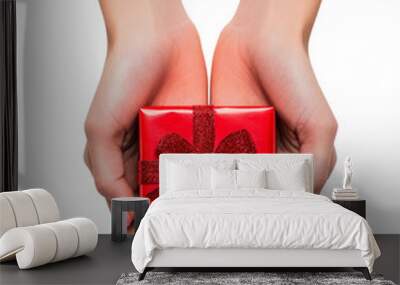 Closeup view of female hands holding a small red gift box with a red bow isolated on transparent background, PNG cutout.  Wall mural