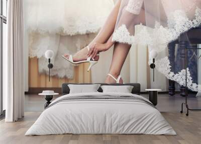 the bride puts on shoes  feet Wall mural