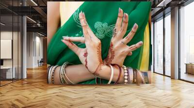 Beautiful woman in traditional Muslim Indian wedding green sari dress costume with henna tattoo jewelry bracelets do hands nritta odissi Samyuta Hasta Mudras dance Movement bird Concept background Wall mural