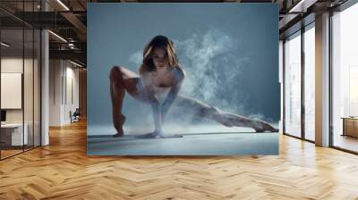 Dancing in cloud concept. Muscle brunette beauty female girl adult woman dancer athlete in fog smoke fume wearing dance bodysuit making sexy dance element performance on isolated grey background Wall mural