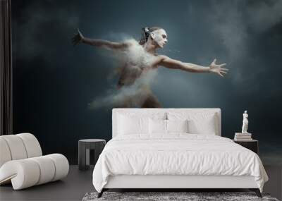 Dancing in flour concept. Long hair muscle fitness guy man male dancer in dust / fog. Guy wearing white shorts making dance element in flour cloud on isolated grey background Wall mural