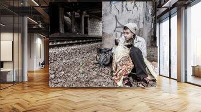 Homeless woman having meal Wall mural