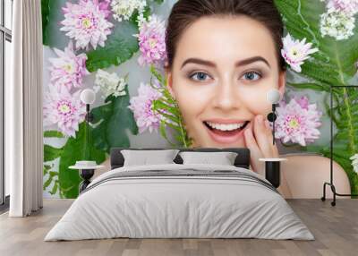 Portrait of young sexy beauty female woman smiling with clean pure skin taking spa relaxing in bath with flowers and green leafs white soap water. Skin beauty health care concept. Body part and nature Wall mural