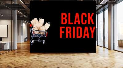 Small metal shopping cart full of craft paper brown package bags  bought at online shopping mall market. Black Friday Sale discount concept. Miniature chrome trolley with presents from grocery store. Wall mural