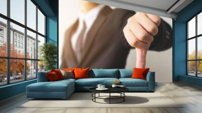 Businessman hand showing thumb down sign gesture. Dislike or bad concept Wall mural