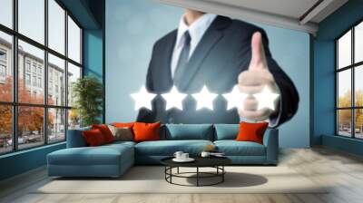 Businessman showing hand sign thumb up and five star symbol to increase rating of company, The excellence of the business or service concept Wall mural