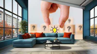 Concept creative idea and innovation. Hand picked wooden cube block with question mark symbol and light bulb icon Wall mural