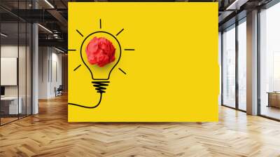 Creative thinking ideas and innovation concept. Paper scrap ball red colour with light bulb symbol on yellow background Wall mural