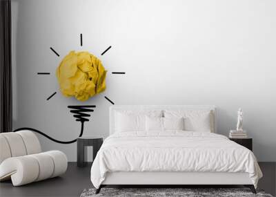 Creative thinking ideas and innovation concept. Paper scrap ball yellow colour with light bulb symbol on white background Wall mural