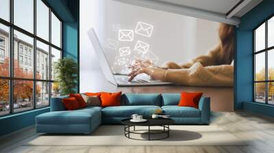 email marketing and newsletter concept. woman using computer laptop and sending online message with  Wall mural