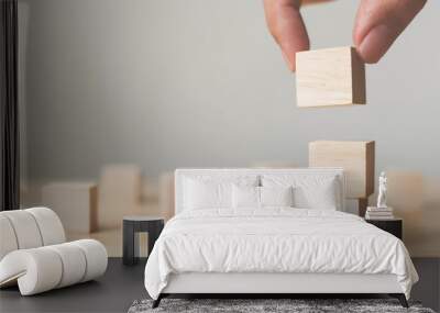 hand arranging wood block stacking on top with wooden table. business concept for growth success pro Wall mural