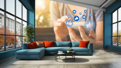 Social network sharing and commenting in the online community, Woman hand holding smartphone and using application social media Wall mural