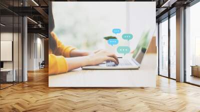 Woman using computer laptop on wood desk. Online live chat chatting on application communication digital media website and social network Wall mural