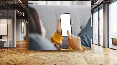 Woman using mobile smartphone and device white screen empty space smart phone, clipping path included Wall mural