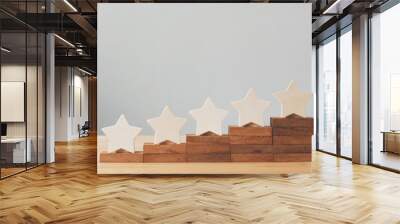 Wooden five star shape on table. The best excellent business services rating customer experience concept Wall mural