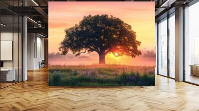 A serene landscape featuring a majestic tree silhouetted against a vibrant sunset, encapsulating nature's beauty and tranquility. Wall mural