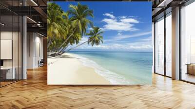 A serene tropical beach with vibrant palm trees, soft sand, and clear blue water under a bright sky, perfect for relaxation. Wall mural