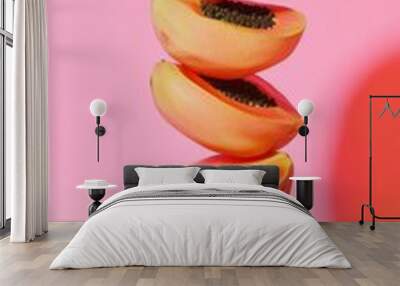 A stack of papaya slice fruit balancing on top with solid background Wall mural