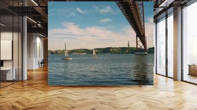 April 25 Bridge on the Tagus River in Lisbon, Portugal. In the background is a statue of Jesus Christ. Wall mural