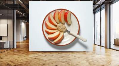 Sliced apples with peanut butter on a plate. Vegetarian breakfast. Wall mural