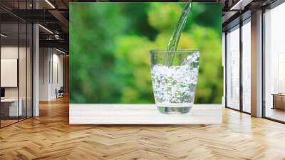 Closeup Glass of water on table nature background Wall mural