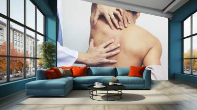 Closeup of Doctor examines or treatment the man with shoulder pain or neck pain on white background,Health concept Wall mural