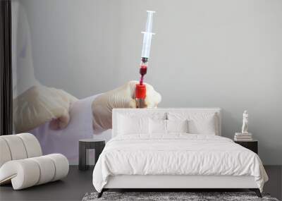 Doctor hand holding blood collection tubes in hematology laboratory, Medicine and science concept Wall mural