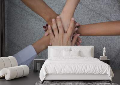 Meeting teamwork concept,Friendship,Group people with stack of hands showing unity on white background Wall mural