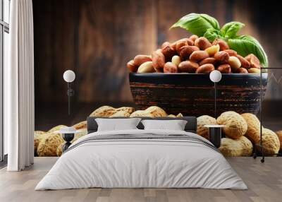 Bowl with peanuts on wooden table. Wall mural