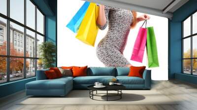 Young woman with shopping bags isolated on white Wall mural