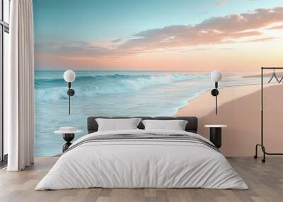 A serene view of a sandy beach at sunset, with gentle waves lapping the shore under a pastel sky. Wall mural