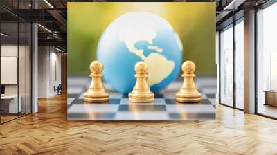 Board game, business and planning concept. Close up of gold chess pieces on chessboard with mini world ball and green nature background. Wall mural