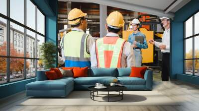 woman worker and engineer under inspection and checking production process on factory station. Factory Engineer. Professional Heavy Industry Engineer Worker. Team of factory workers. Wall mural