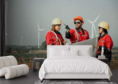 Young man and woman maintenance engineer team. two engineer operate wind turbine. Engineer and worker discussing on a wind turbine farm. Wind Turbine. Maintenance Workers. renewable energies.. Wall mural