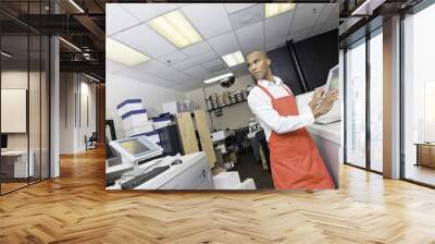 African American man working at printing press Wall mural