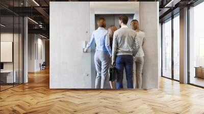 Business people waiting for elevator in office Wall mural