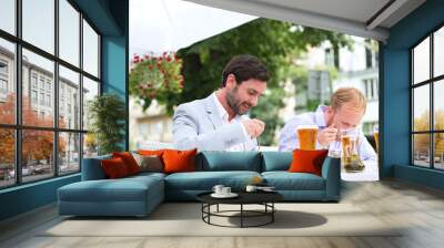 Businessmen eating food at outdoor restaurant Wall mural