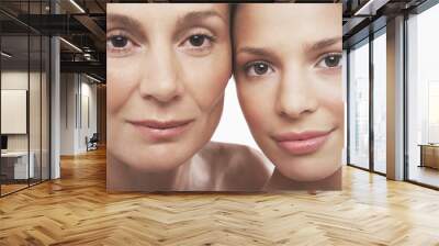 closeup portrait of two beautiful women smiling on white background Wall mural