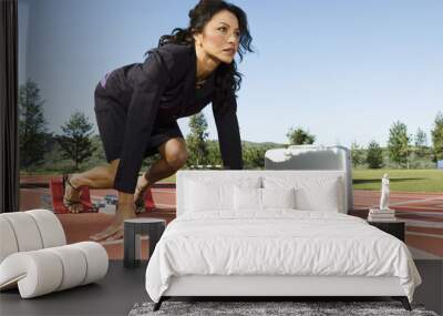 Confident businesswoman with briefcase at starting blocks Wall mural