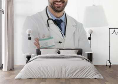 Confident doctor standing with arms crossed in clinic Wall mural